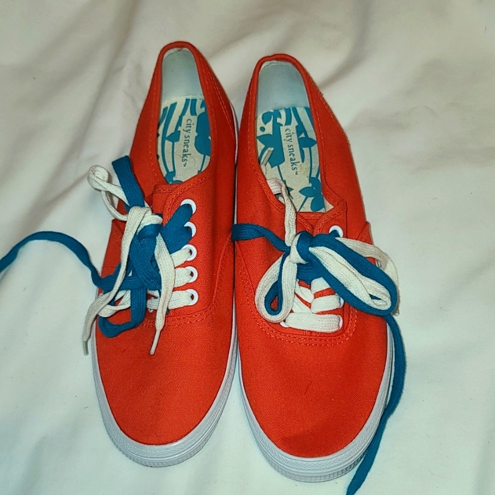 Ladies coral colored pair sneakers
